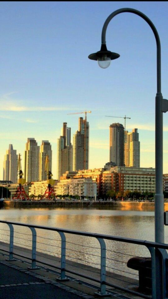 Waterfront promenade with city skyline view